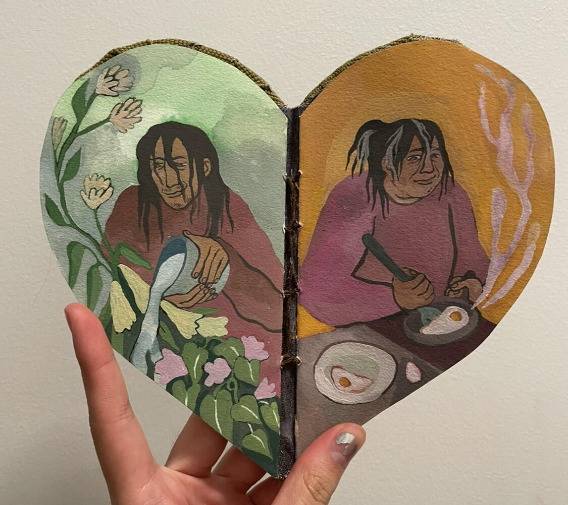 The picture above is a full spread from the book. A tan hand is holding the book open to show the illustrated pages and the heart shape of the book. The illustrations are cool to warm toned with a painterly feel.